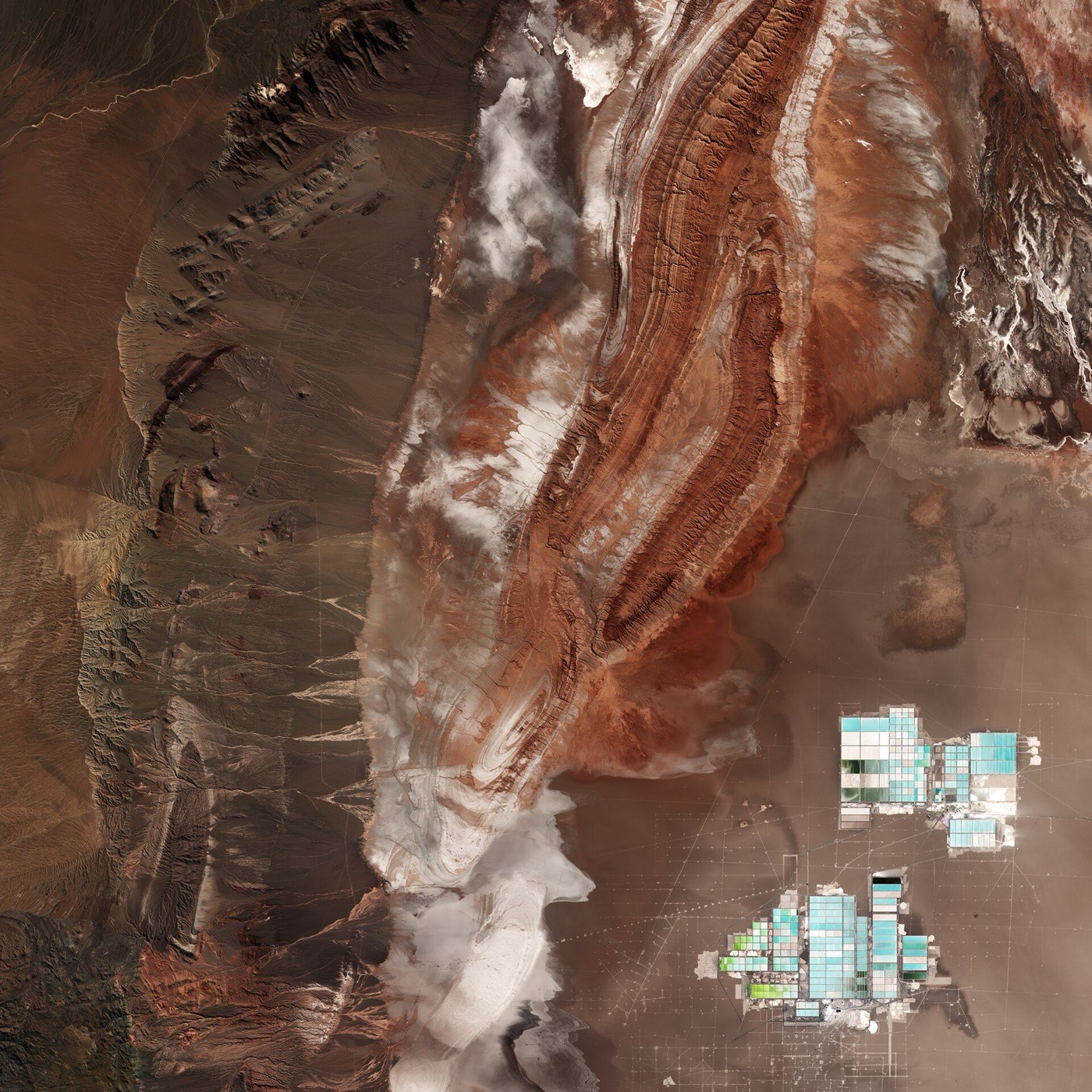 Sentinel-2 satellite image of the Salar de Atacama, Chile: brown and white evaporite terrain with the turquoise rectangles of lithium brine evaporation ponds at lower right.